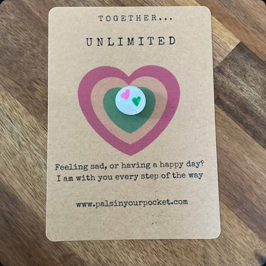 Card with a heart design and text on a wooden surface