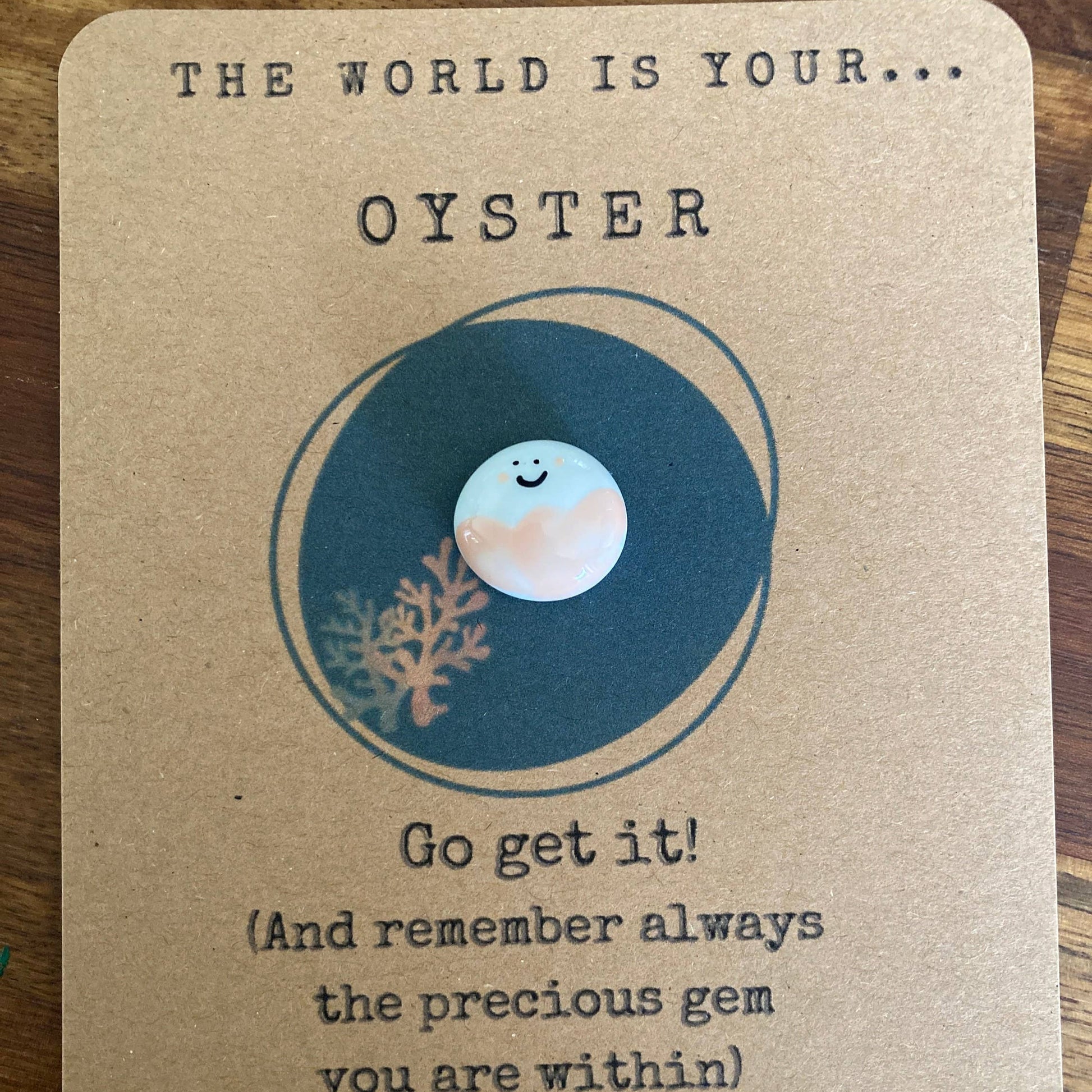 Motivational card with ocean-themed illustration and text on a wooden surface