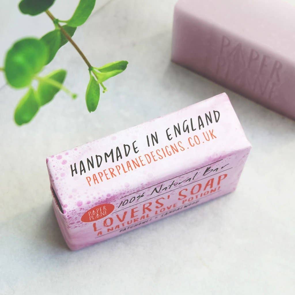 Bar of soap with packaging labeled 'Handmade in England' on a light surface.