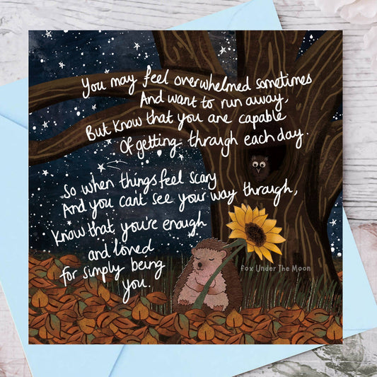 Card with hedgehog and sunflower design, featuring a motivational quote on a starry night background.