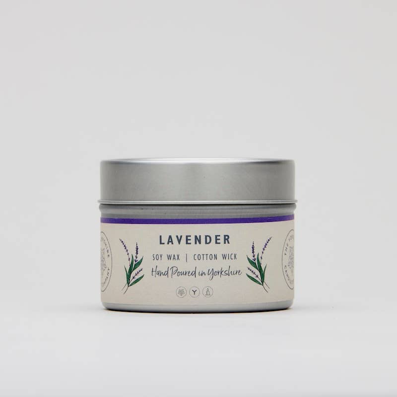Lavender candle in a tin with a white label on a light gray background
