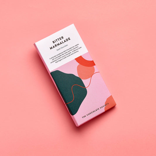 Chocolate bar packaging with abstract design on a pink background