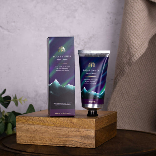 Polar Lights hand cream packaging on a wooden block with a neutral background