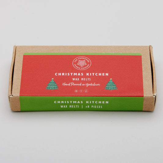 Box of Christmas Kitchen wax melts on a light gray background