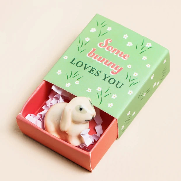Lisa Angel ceramic bunny token in a green and pink matchbox with Some Bunny Loves You on the lid