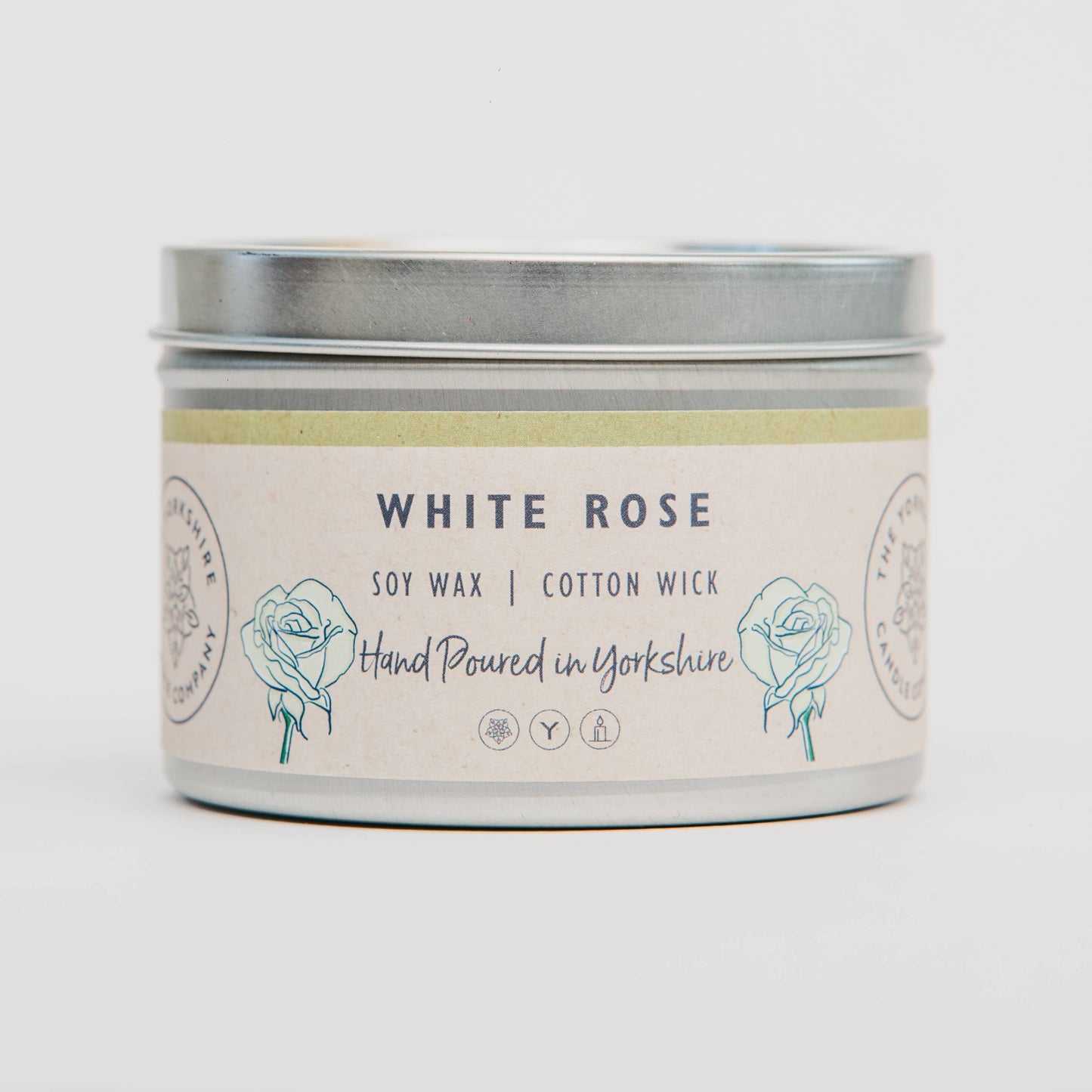 Candle tin labeled 'White Rose' with soy wax and cotton wick on a light background