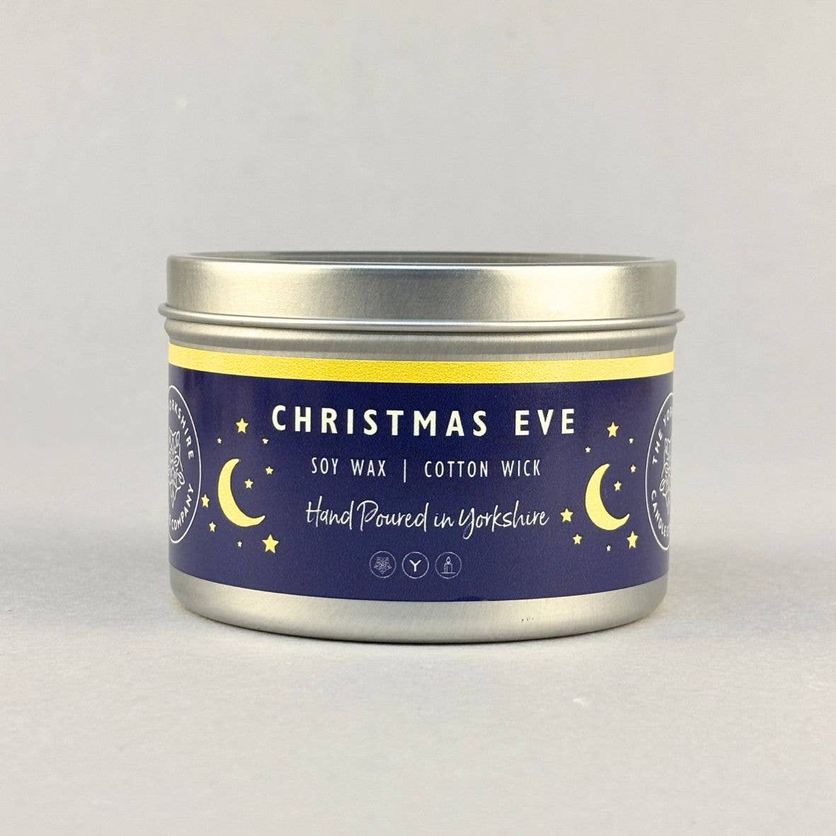 Silver Christmas Eve candle tin with a navy and gold moon-and-star label