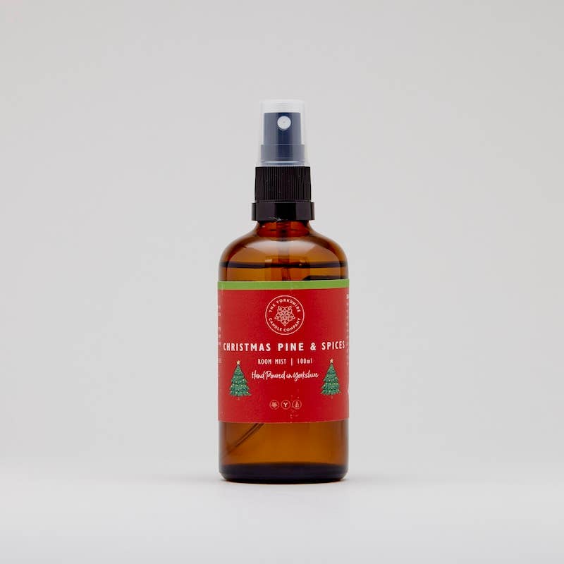 Christmas Pine & Spices room mist in an amber spray bottle with a red and green label
